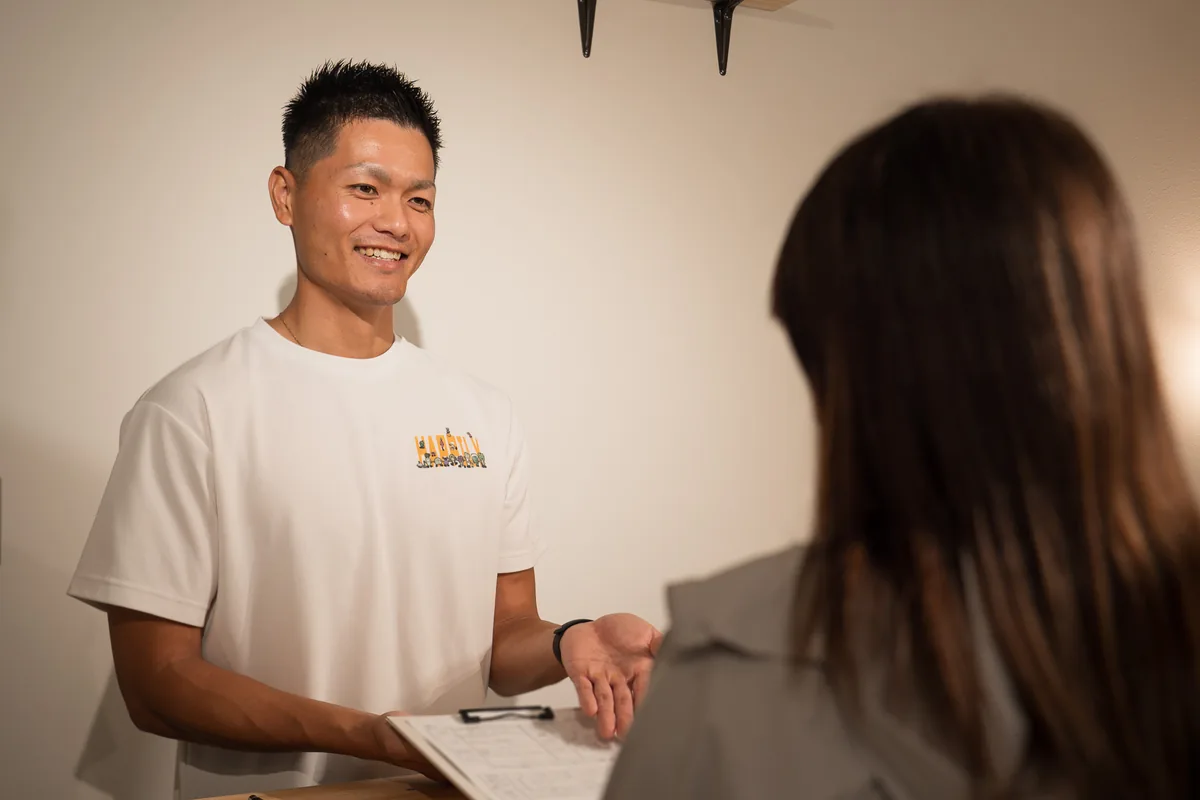 Happilyでトレーナーから初回体験の説明を受ける女性